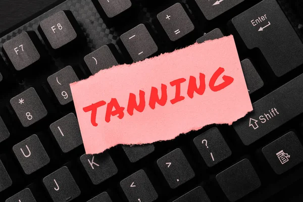 Text caption presenting Tanning, Business approach a natural darkening of the scin tissues after exposure to the sun