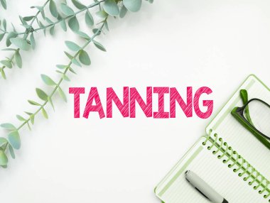 Text caption presenting Tanning, Business concept a natural darkening of the scin tissues after exposure to the sun