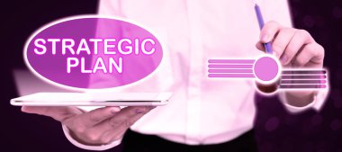 Conceptual caption Strategic Plan, Word for A process of defining strategy and making decisions