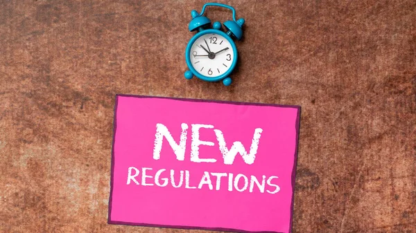 Sign displaying New Regulations, Business idea Regulation controlling the activity usually used by rules.