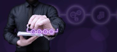 Businessman in suit holding tablet and pen. Futuristic image with glow.