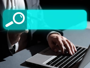 Man in office suit sitting at the table with lap top and typing text.