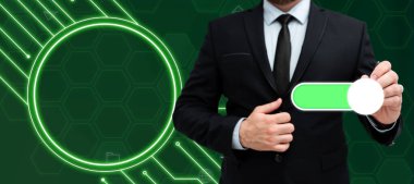 Man in black suit standing with pen and pressing virtual button.