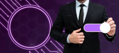 Man in black suit standing with pen and pressing virtual button.