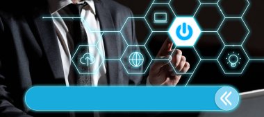 Businessman sitting at the table ant typing important message with laptop.