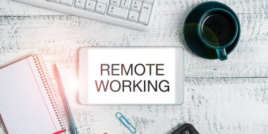 Hand writing sign Remote Working, Business concept situation in which an employee works mainly from home