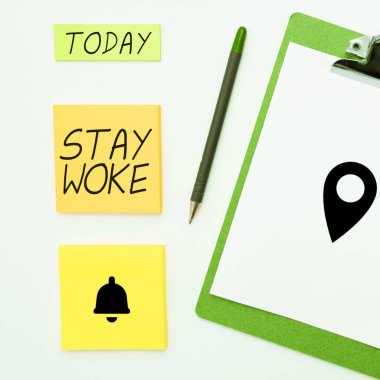 Hand writing sign Stay Woke, Conceptual photo being aware of your surroundings and things going on Keep informed