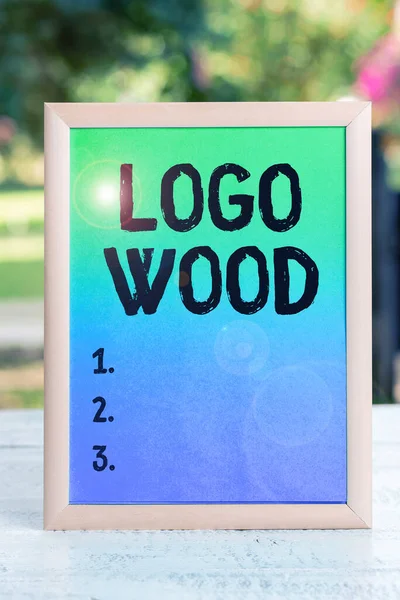 Text sign showing Logo Wood, Concept meaning Recognizable design or symbol of a company inscribed on wood