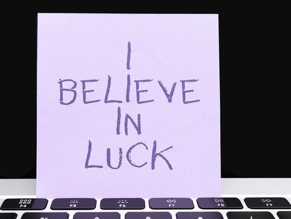 Hand writing sign I Believe In Luck, Concept meaning to have faith in lucky charms superstition thinking