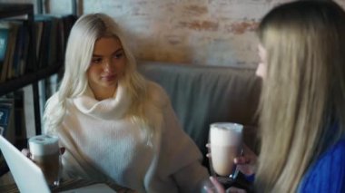 Business meeting of two women in a coffee shop.