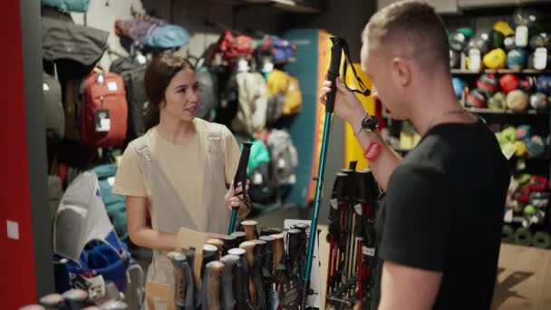 Couple Looking Nordic Walking Sticks Sporting Goods Store — Stockvideo