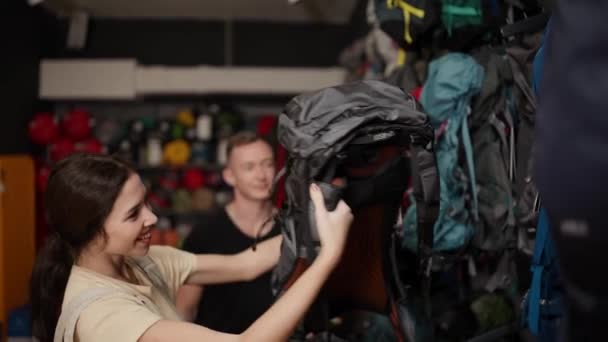 Lovely Couple Examining Various Rucksacks Sports Equipment Store — Stok video