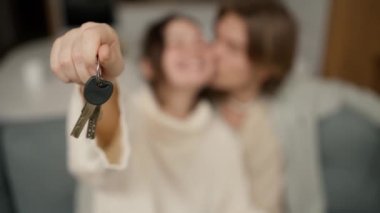 Blurred footage couple in living room show keys from first house.
