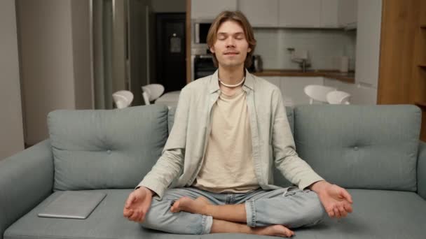 Young Man Starts Meditate His Living Room Couch — Stock video
