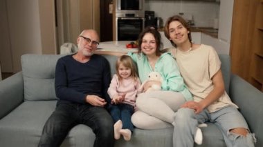 Portrait of happy family, grandpa together with his grandkids at home.