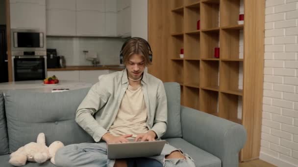Young Man Headphones Make Video Call Using Laptop Sitting Home — Vídeos de Stock