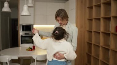 Loving couple slow dance at home.