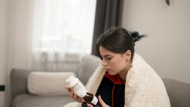 Sick Woman Blanket Reading Labels Choosing Two Bottles — 비디오