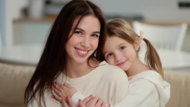 Portrait of little cute girl bonding her mom for a picture.