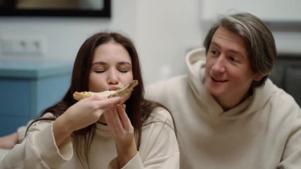 Young Woman Eats Pizza Offers Bite Boyfriend Feeling Happy — Stock video