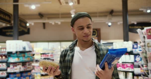 Guy Chooses Products Grocery Store Thinking Cooked Raw Pasta — Stock Video