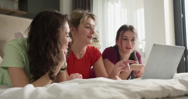 Χαμογελώντας Τρεις Όμορφες Γυναίκες Ξαπλωμένες Μαζί Στο Κρεβάτι Και Σερφάροντας — Αρχείο Βίντεο