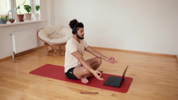 Mixed Race Man Headphones Meditates Front Laptop Instructor — Stock Video