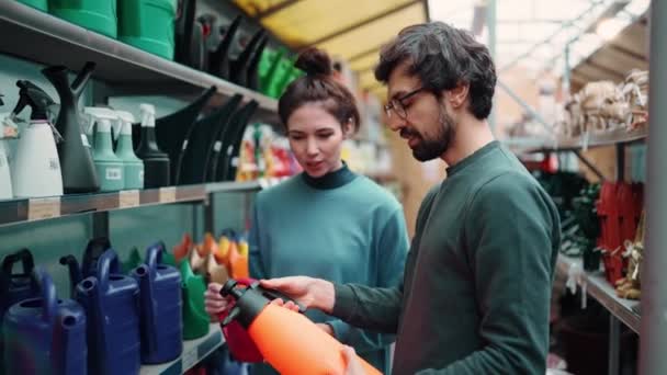 Portrait Positive Young Couple Garden Store Choosing Sprayer — Stock Video