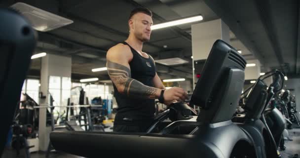 Young Athlete Tattoo Starts His Work Treadmill Setting Sports Equipment — Stock Video