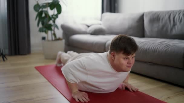 Hombre Discapacitado Enfocado Con Síndrome Haciendo Flexiones Estera Sala Estar — Vídeos de Stock