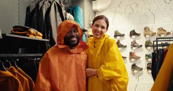 Joyful Adventure Afro American Guy European Girl Colorful Raincoats — Stock Video