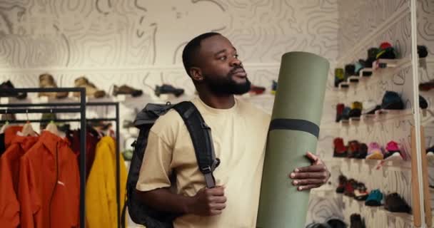 Trailblazing Smiles Afroamerican Man Explores Camping Store Radiant Spirit — Αρχείο Βίντεο