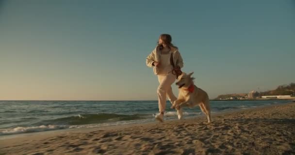 Joggen Spelen Met Haar Huisdieren Een Blond Meisje Het Strand — Stockvideo