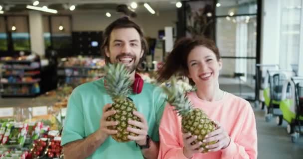 Harmonious Citrus Moves Playful Brunette Duo Showcasing Fun Pineapple Presentation — Stock Video