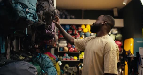 Black Man Inspiring Journey Find Perfect Backpack Vibrant Summer Park — Αρχείο Βίντεο