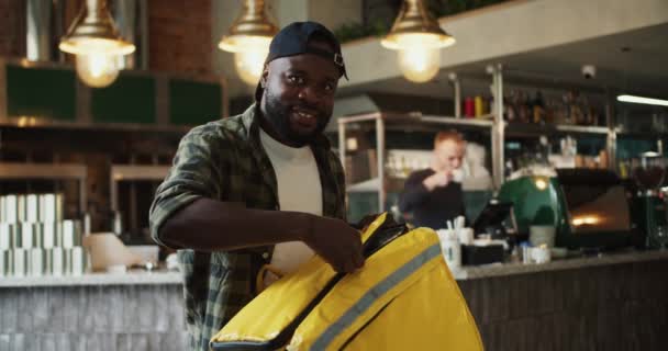 Food Delivery Man Plaid Shirt Black Cap Poses Smiles Doner — Stock Video