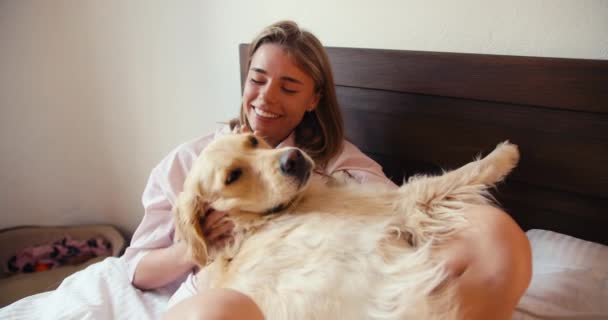 Blonde Girl White Nightgown Hugs Her Dog Light Coloring Lying — Stock Video