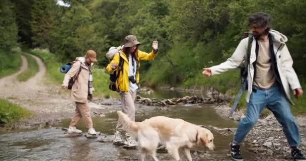 Chlápek Pomáhá Dvěma Holkám Přejít Horskou Řeku Speciálních Kamenech Podá — Stock video