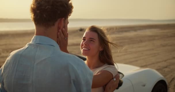 快乐的女孩在外面一辆白色轿车旁边摸着长胡子男朋友的脸颊 在一个阳光灿烂的夏夜 一个女孩和一个男孩在约会 — 图库视频影像