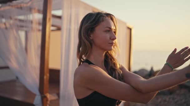 Młoda Wysportowana Blondynka Czarnej Bluzce Ćwicząca Jogę Plaży Rozciągająca Ramiona — Wideo stockowe