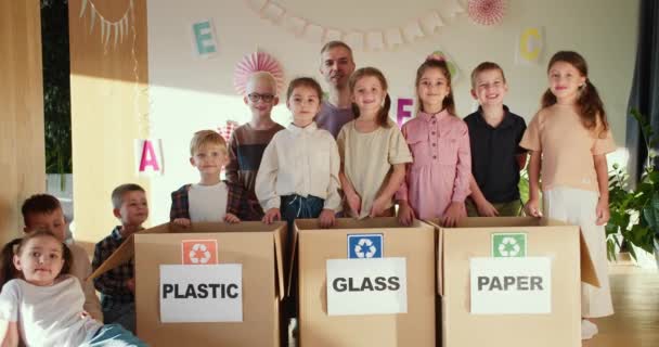 Portret Szczęśliwych Dzieci Wraz Nauczycielem Pobliżu Specjalnych Pudełek Sortowania Śmieci — Wideo stockowe