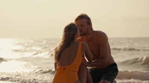Blonde Girl Orange Swimsuit Kisses Her Blonde Boyfriend Bare Torso — Stock Video
