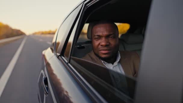 Suspicious Black Man Dissatisfied Face Brown Suit Opens Rear Window — Stock Video