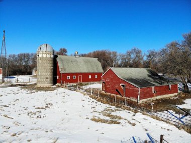 A working farm complete with its old red barns clipart