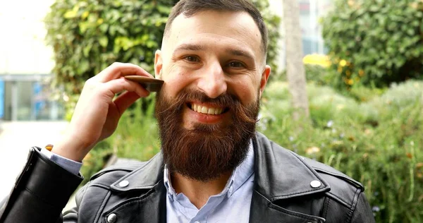 Young Bearded Man Brushing His Beard Outdoor — Stock Photo, Image