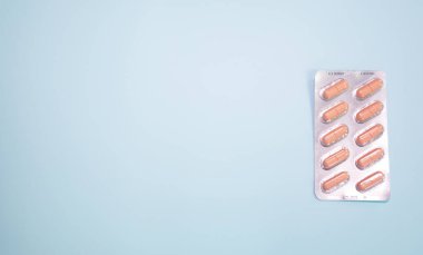 close-up view of blister pack with pills on blue background