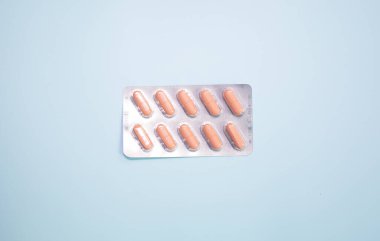 close-up view of blister pack with pills on blue background
