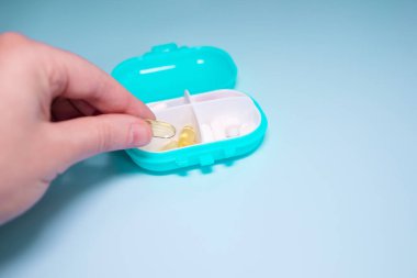 Senior woman organizing medication into pill dispenser. Senior woman taking pills from box. Healthcare and old age concept with medicines.