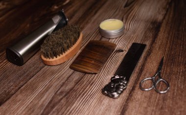 Different combs, brushes and other tools for grooming a beard. Close up view. 