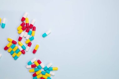 pharmaceutical medicine pills, tablets and capsules on blue background. Medicine concept.  